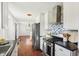 Modern kitchen boasting stainless steel appliances, white cabinets, and sleek countertops, seamlessly flowing into the adjacent living space at 1953 N Linwood Ave, Indianapolis, IN 46218