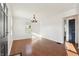 Bright living room boasting hardwood floors, white walls, and a modern chandelier, offering a comfortable living space at 1953 N Linwood Ave, Indianapolis, IN 46218