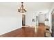 Bright living room featuring hardwood floors, white walls, and modern chandelier, creating an open and inviting space at 1953 N Linwood Ave, Indianapolis, IN 46218