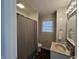 A bathroom features a toilet, window, walk-in shower with curtain, and a granite-look vanity at 2341 California St, Columbus, IN 47201