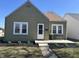 Charming home features meticulous landscaping, covered porch, and a well-maintained exterior at 2341 California St, Columbus, IN 47201
