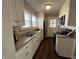 This well-lit kitchen features sleek white cabinetry, modern appliances, and a window for natural light at 2341 California St, Columbus, IN 47201