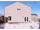 Home's back exterior shows its simple design with siding, windows, and a door leading to a snowy backyard at 2365 Grand Fir Dr, Greenwood, IN 46143