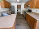 Functional kitchen boasts wood cabinets, stainless steel appliances, and sleek countertops for easy meal preparation at 2365 Grand Fir Dr, Greenwood, IN 46143