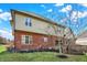 A beautiful house with brick and vinyl siding, a manicured lawn, and a stone retaining wall at 2750 Joshua Dr, Carmel, IN 46033