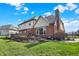 Brick home with a multi-tiered brick patio at 2750 Joshua Dr, Carmel, IN 46033