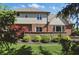 Charming backyard featuring lush green lawn and a brick house with an outdoor patio at 2750 Joshua Dr, Carmel, IN 46033