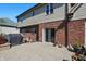 Brick and vinyl home exterior with a patio space, featuring sliding doors, barbecue and lush potted flowers at 2750 Joshua Dr, Carmel, IN 46033