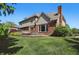 Charming backyard featuring lush green lawn and a brick house with an outdoor patio at 2750 Joshua Dr, Carmel, IN 46033