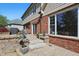 Backyard features a brick home with a stone patio with stone stairs, a grill and lovely landscaping at 2750 Joshua Dr, Carmel, IN 46033