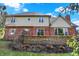 Lovely brick house with a stone retaining wall and beautiful backyard with blue sky at 2750 Joshua Dr, Carmel, IN 46033