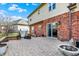 Relaxing brick paver patio with built in grill and backyard surrounded by trees and lush grass at 2750 Joshua Dr, Carmel, IN 46033
