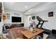Finished basement offers a table, TV, exercise equipment, and accent rug at 2750 Joshua Dr, Carmel, IN 46033