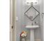 Powder room features pedestal sink and decorative mirror at 2750 Joshua Dr, Carmel, IN 46033