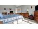 Bedroom displays a bed, desk, dresser, and shelving against a muted, gray wall at 2750 Joshua Dr, Carmel, IN 46033