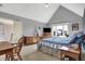 Neutral bedroom boasts a ceiling fan, sitting area, and dresser topped with a TV near bright windows at 2750 Joshua Dr, Carmel, IN 46033
