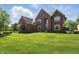 Beautiful brick home with a well-manicured lawn and lush landscaping at 2750 Joshua Dr, Carmel, IN 46033