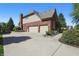 Long driveway with an attached brick two-car garage at 2750 Joshua Dr, Carmel, IN 46033