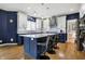 Modern kitchen island featuring barstool seating and contrasting dark blue cabinets at 2750 Joshua Dr, Carmel, IN 46033