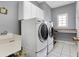 Functional laundry room with sink, counter, and newer washer-dryer at 2750 Joshua Dr, Carmel, IN 46033