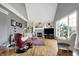 Bright living room with fireplace, built-in shelving, hardwood floors, and large windows offering natural light at 2750 Joshua Dr, Carmel, IN 46033