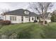 Well-maintained lawn and landscaping compliment the white brick exterior, creating a serene backyard setting at 2861 Shadwell Pl, Greenwood, IN 46143