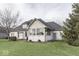 Expansive backyard with an enclosed sunroom and outdoor seating featuring a large lawn and mature landscaping at 2861 Shadwell Pl, Greenwood, IN 46143