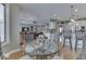 Open concept dining area with a glass table set and bar seating looking into the kitchen at 2861 Shadwell Pl, Greenwood, IN 46143