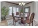 Formal dining room with chandelier, decorative mirror, and a large window at 2861 Shadwell Pl, Greenwood, IN 46143