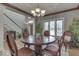 Formal dining room with chandelier, decorative mirror, and large window at 2861 Shadwell Pl, Greenwood, IN 46143