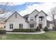Beautiful two-story white brick home with well-manicured lawn and mature landscaping at 2861 Shadwell Pl, Greenwood, IN 46143