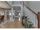 Open foyer with staircase, wood floors, neutral walls, and views into other living spaces at 2861 Shadwell Pl, Greenwood, IN 46143