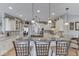 Bright, open kitchen with a large island, bar stools, stainless steel appliances, and pendant lighting at 2861 Shadwell Pl, Greenwood, IN 46143
