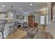 Cozy living room next to the kitchen with a comfortable armchair, rug and plenty of natural light at 2861 Shadwell Pl, Greenwood, IN 46143