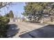 View of backyard with mature trees and storage sheds and a concrete pad at 3044 S Keystone Ave, Indianapolis, IN 46237