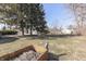Home backyard featuring mature trees, mulch, and unique yard decor at 3044 S Keystone Ave, Indianapolis, IN 46237