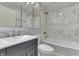 This updated bathroom features modern fixtures, a stylish vanity, and a shower-tub combination with tiled walls at 3044 S Keystone Ave, Indianapolis, IN 46237