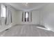 Bright bedroom with neutral carpet, light walls, two windows and modern lighting, offering comfort and style at 3044 S Keystone Ave, Indianapolis, IN 46237