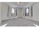 A bright bedroom features neutral carpet, light walls, and two windows, offering a serene and comfortable space at 3044 S Keystone Ave, Indianapolis, IN 46237