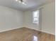 A bright bedroom with hardwood floors, natural light, and a view of the outdoors creates a cozy atmosphere at 3044 S Keystone Ave, Indianapolis, IN 46237