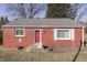 Charming single-story home with a bright red door and classic brick exterior at 3044 S Keystone Ave, Indianapolis, IN 46237
