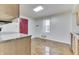 Efficient kitchen layout with a red door and hardwood floors, blending style and functionality at 3044 S Keystone Ave, Indianapolis, IN 46237