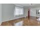 Open living room with hardwood floors and a large window, offering plenty of natural light at 3044 S Keystone Ave, Indianapolis, IN 46237
