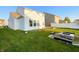 Spacious backyard area, featuring a home with a sunroom and an outdoor firepit at 3153 Underwood Dr, Whiteland, IN 46184