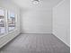 Bright, carpeted room with large windows, and detailed trim, perfect for a dining room or office at 3153 Underwood Dr, Whiteland, IN 46184