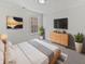 Serene main bedroom with soft lighting, modern decor, a large window, and a comfortable bed at 3153 Underwood Dr, Whiteland, IN 46184