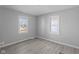 Bright bedroom featuring neutral walls, new laminate flooring, and natural light from two windows at 3701 N Temple Ave, Indianapolis, IN 46218