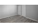 Bedroom with laminate flooring, neutral paint, and built-in closet, offering a clean and functional space at 3701 N Temple Ave, Indianapolis, IN 46218