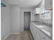 Modern kitchen featuring granite countertops, white cabinets, subway tile backsplash, and new flooring at 3701 N Temple Ave, Indianapolis, IN 46218