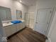 Bathroom featuring a dual sink vanity, neutral walls, and laminate wood flooring at 3912 Bamboo Branch Dr, Clayton, IN 46118